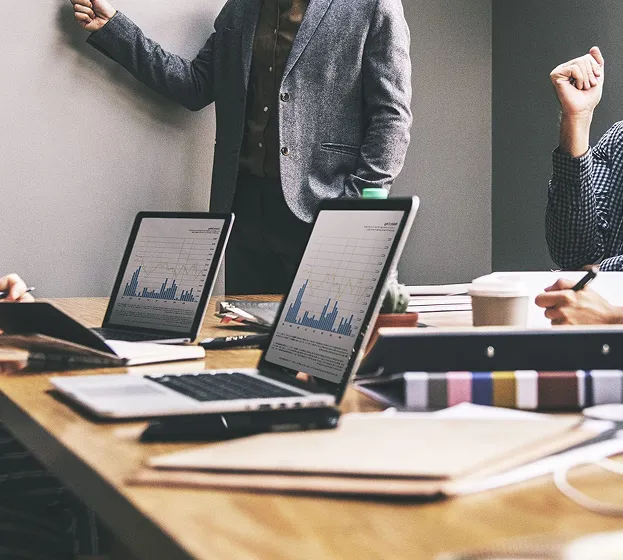 Business Strategy and Data Analysis Meeting Business team meeting analyzing financial charts and marketing strategy